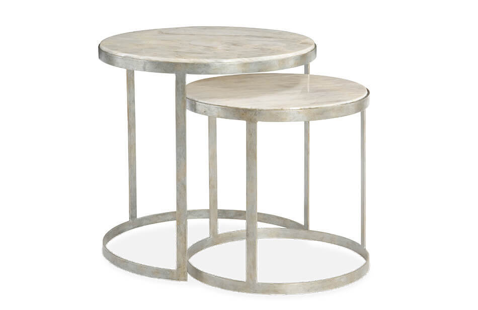 Tiffin Nesting Table, two circular accent tables at slightly different heights with the shorter accent table under the other with rounded silver metal supports